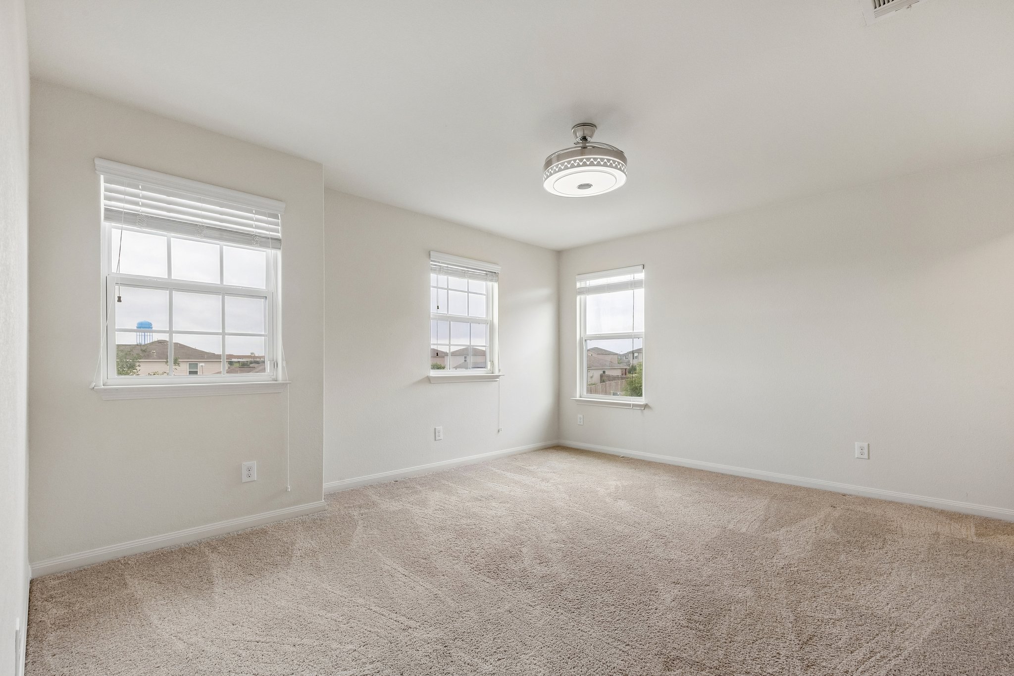 704 Cleary Lane Jarrell, TX 76537 - Photo 17 of 25 Spacious room featuring neutral carpeting and light-colored walls