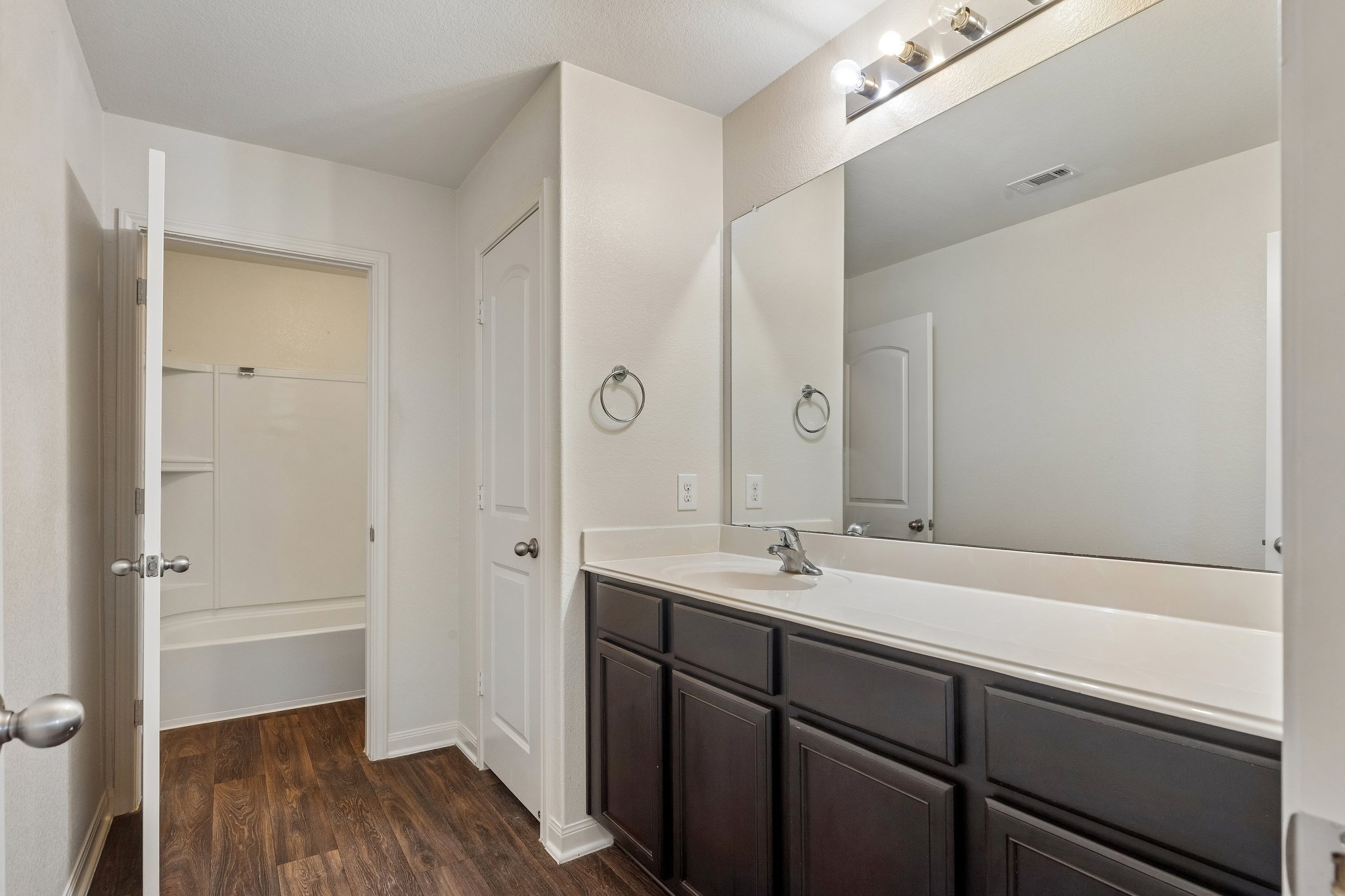 704 Cleary Lane Jarrell, TX 76537 - Photo 22 of 25 Bathroom featuring a dark wood-finish vanity with a white countertop and integrated sink