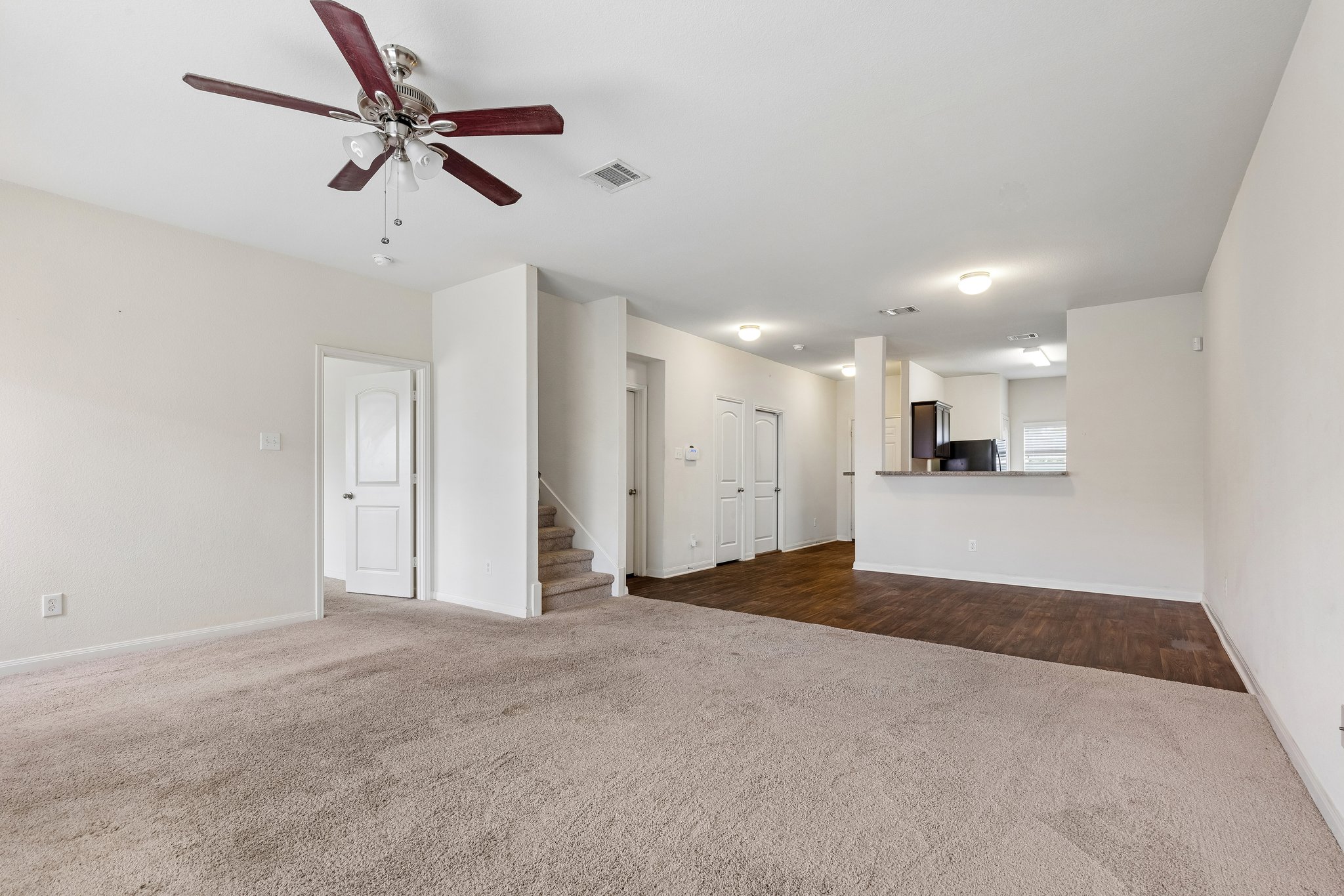 704 Cleary Lane Jarrell, TX 76537 - Photo 5 of 25 Spacious room featuring carpeted flooring, a ceiling fan with integrated lighting, and a neutral wall palette