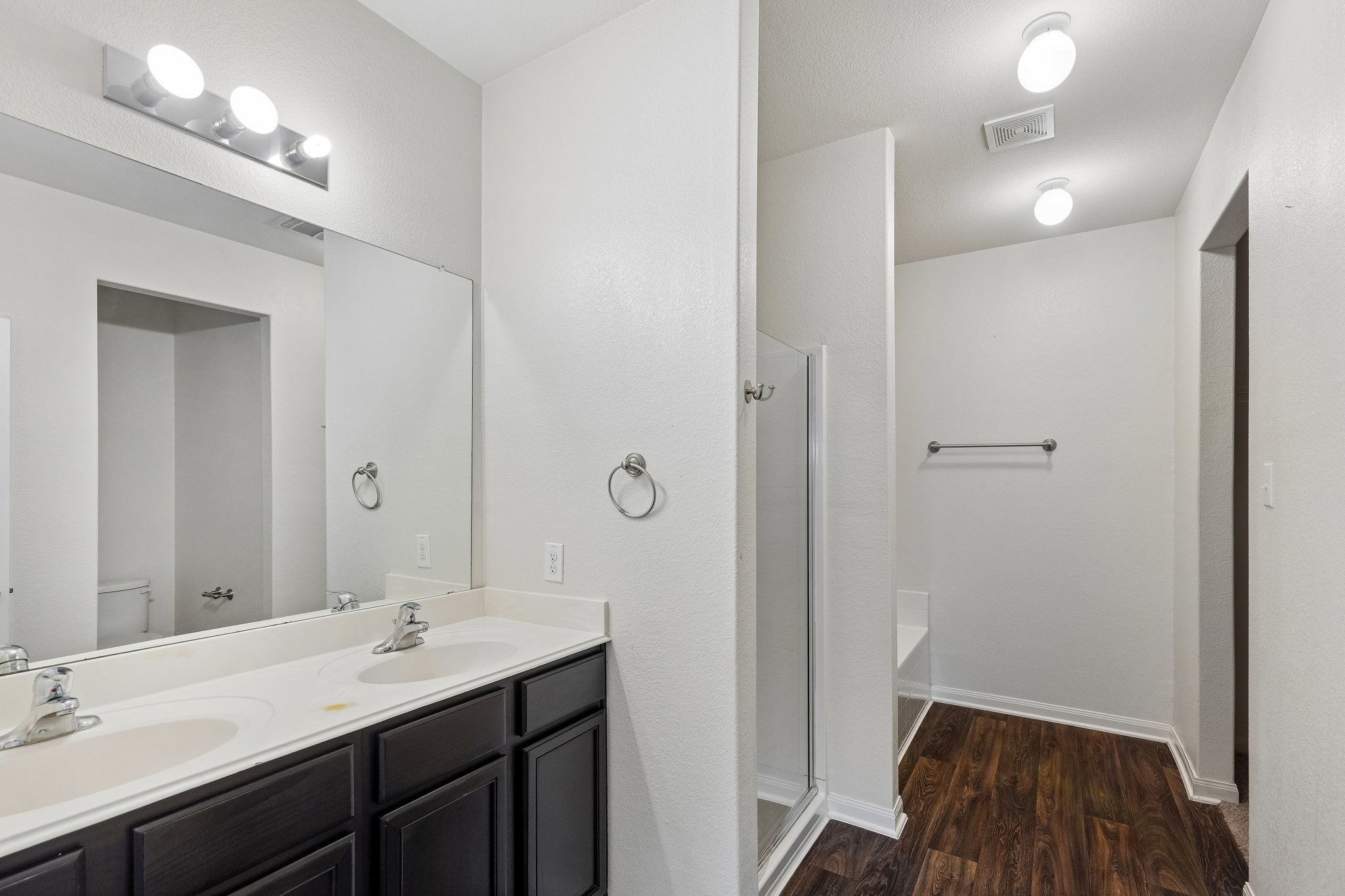 704 Cleary Lane Jarrell, TX 76537 - Photo 7 of 25 Bathroom featuring a double vanity with dark cabinetry and white countertops