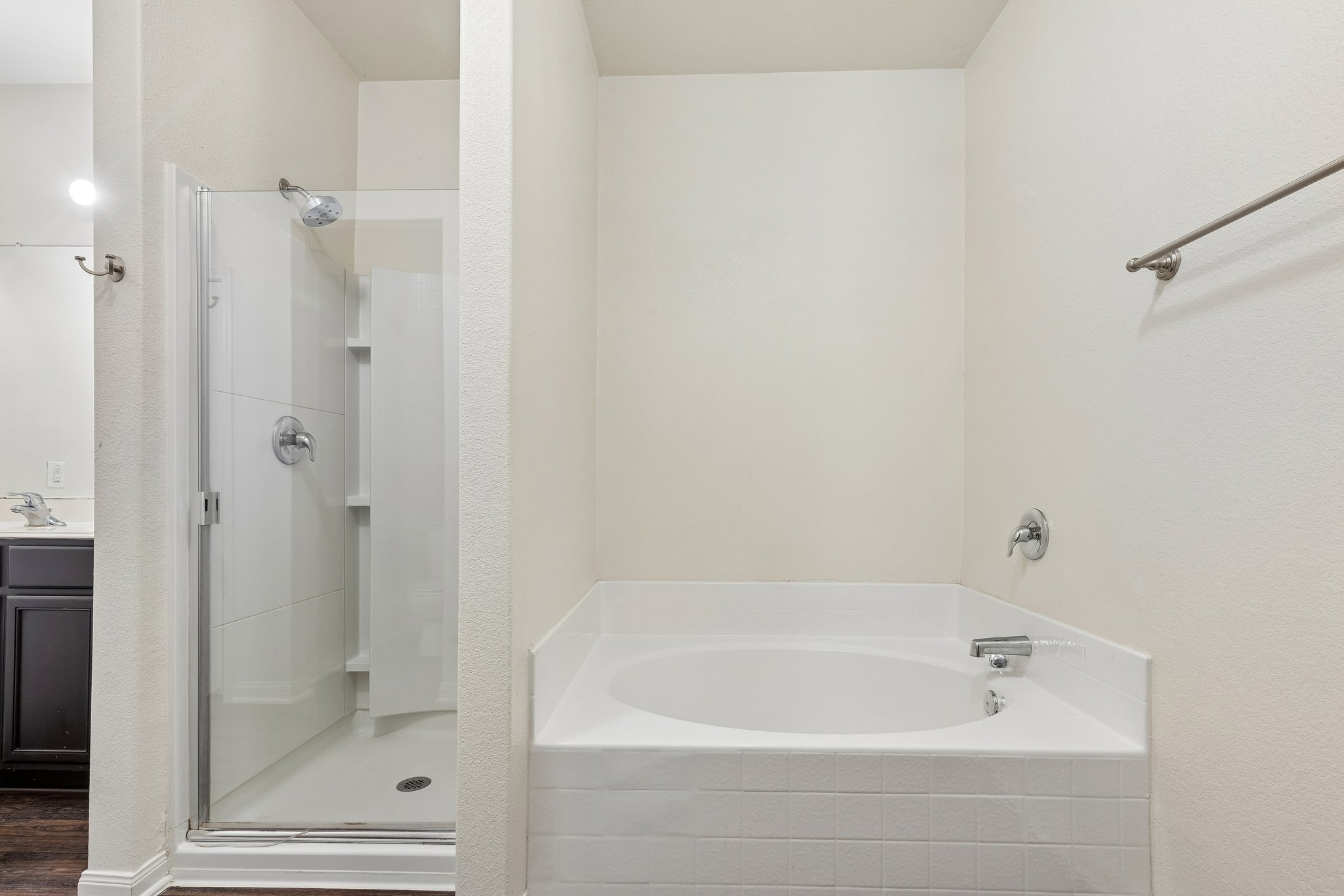 704 Cleary Lane Jarrell, TX 76537 - Photo 8 of 25 Bathroom featuring a built-in soaking tub with white tile surround, a separate glass-enclosed shower, and chrome fixtures