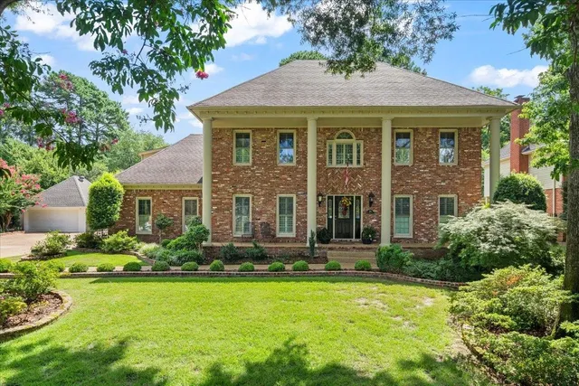 a front view of a house with a yard