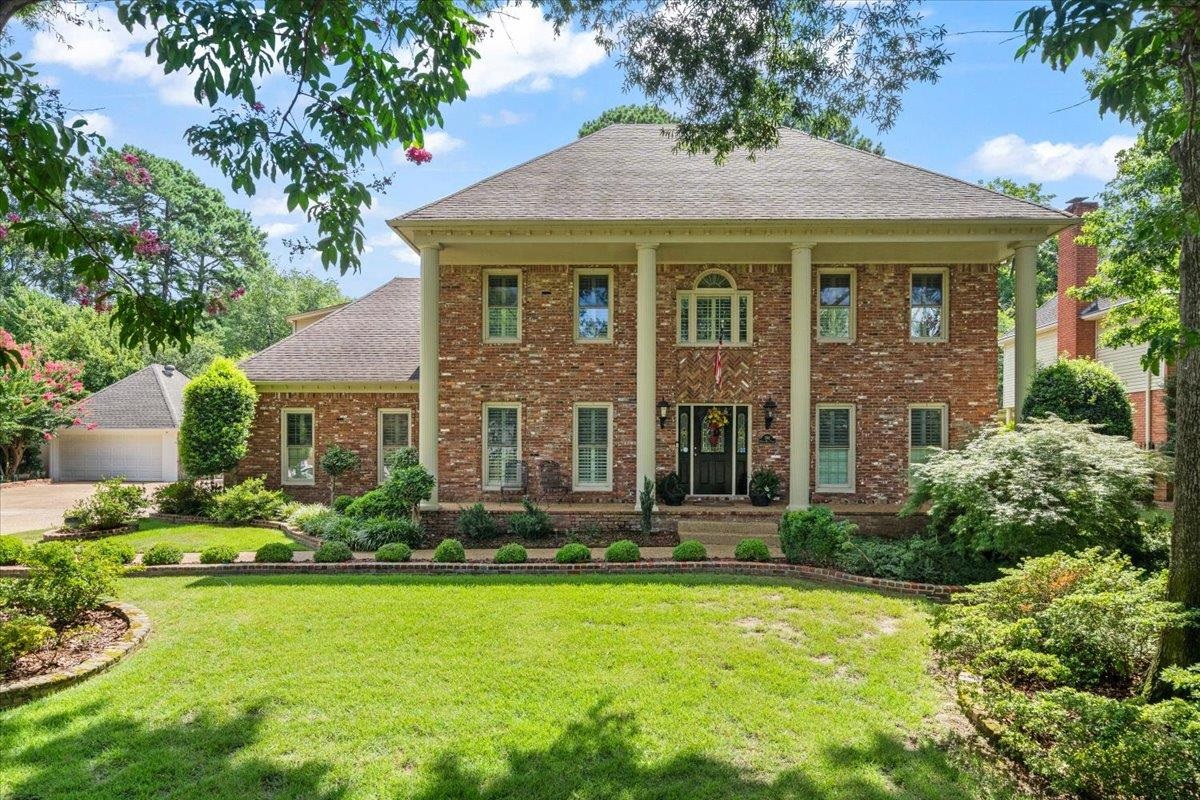 a front view of a house with a yard