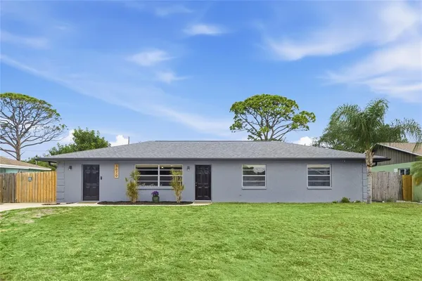 a view of a house with a yard