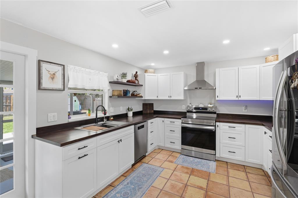 3670 Sunset Beach Drive Venice, FL 34293 - Photo 11 of 51 a kitchen with stainless steel appliances granite countertop a sink and cabinets