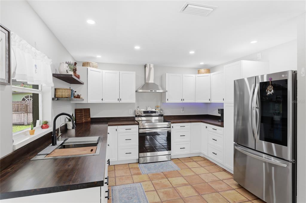 3670 Sunset Beach Drive Venice, FL 34293 - Photo 12 of 51 a kitchen with stainless steel appliances granite countertop a refrigerator and a sink