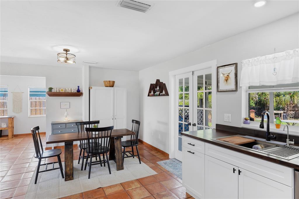 3670 Sunset Beach Drive Venice, FL 34293 - Photo 13 of 51 a dining hall with stainless steel appliances kitchen island granite countertop a table and chairs