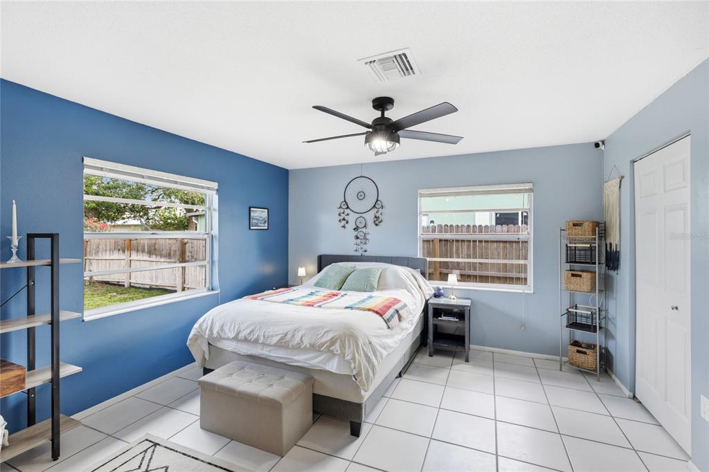3670 Sunset Beach Drive Venice, FL 34293 - Photo 14 of 51 a bedroom with a bed and a chandelier