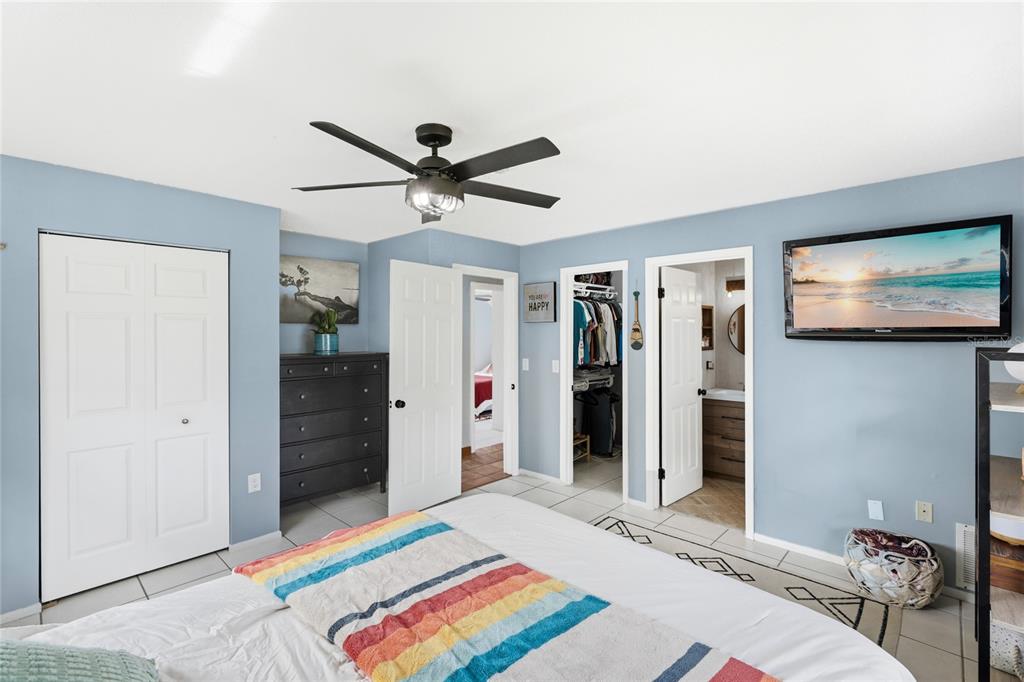 3670 Sunset Beach Drive Venice, FL 34293 - Photo 16 of 51 a bedroom with a bed and a chandelier