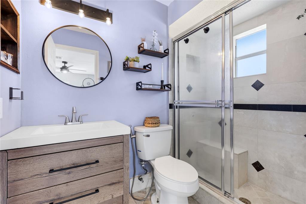 3670 Sunset Beach Drive Venice, FL 34293 - Photo 17 of 51 a bathroom with a sink a toilet and a mirror