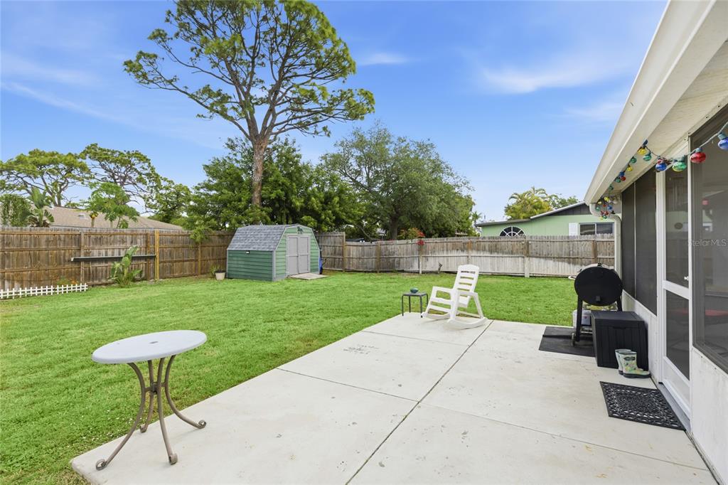 3670 Sunset Beach Drive Venice, FL 34293 - Photo 27 of 51 a view of a backyard with couches table and chairs