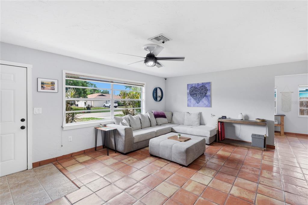 3670 Sunset Beach Drive Venice, FL 34293 - Photo 8 of 51 a living room with furniture and a large window