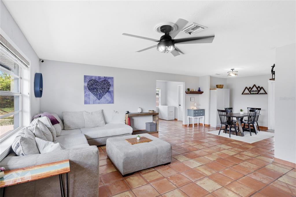 3670 Sunset Beach Drive Venice, FL 34293 - Photo 9 of 51 a living room with furniture and a large window