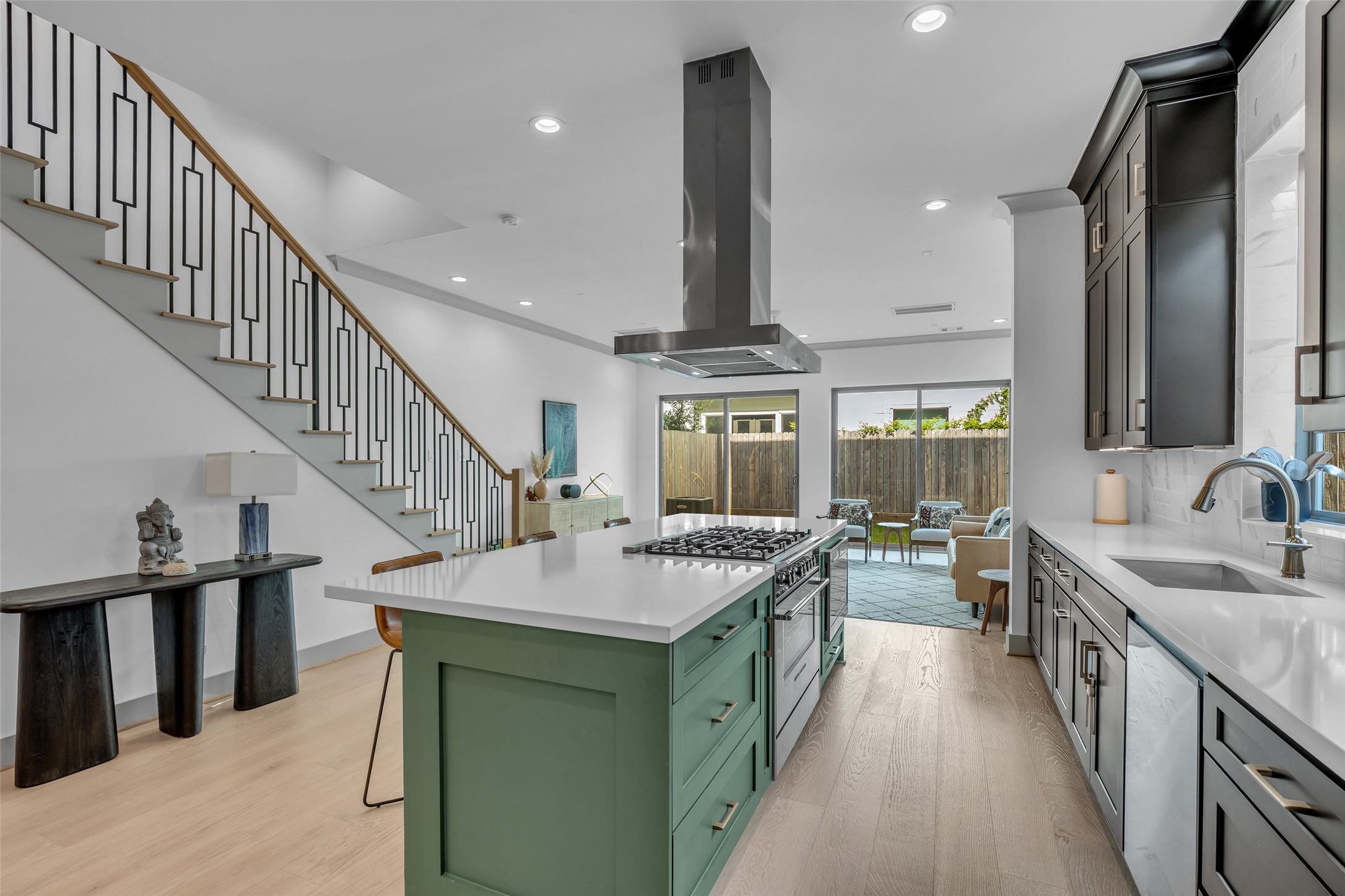 1724 Ridgewood Street Houston, TX 77006 - Photo 7 of 38 From the kitchen, you have a clear view of the dining area directly across, while the sightline extends through to the backyard, creating an open and connected feel.