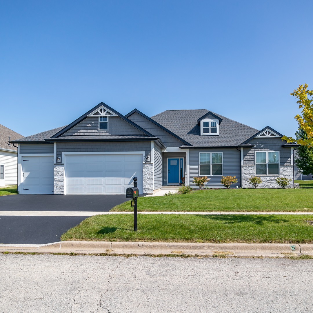 122 West Cache Isle Circle Channahon, IL 60410 - Photo 2 of 47 a front view of a house with a garden and trees