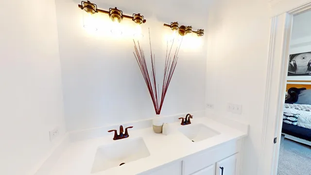 a white toilet sitting next to a white vanity