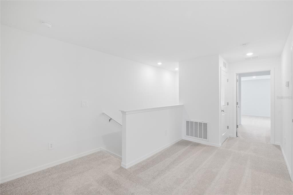 36148 Risa Michele Street Zephyrhills, FL 33541 - Photo 17 of 34 an empty room with white walls and tiles