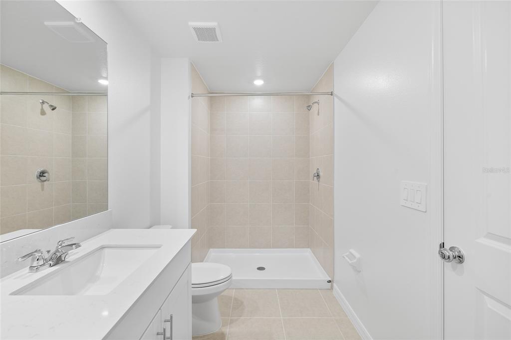 36148 Risa Michele Street Zephyrhills, FL 33541 - Photo 21 of 34 a bathroom with a sink a toilet and shower