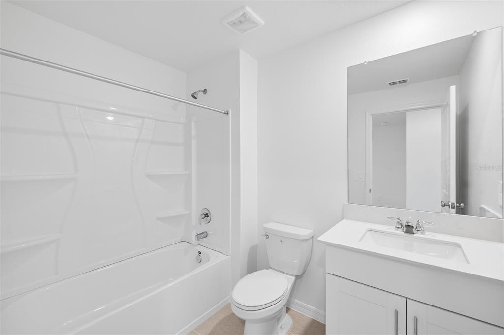 36148 Risa Michele Street Zephyrhills, FL 33541 - Photo 28 of 34 a bathroom with a sink toilet and shower