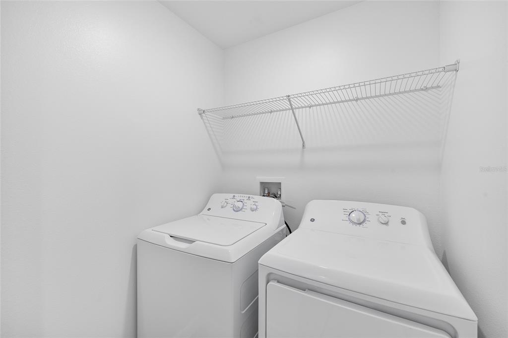 36148 Risa Michele Street Zephyrhills, FL 33541 - Photo 31 of 34 a utility room with dryer and washer