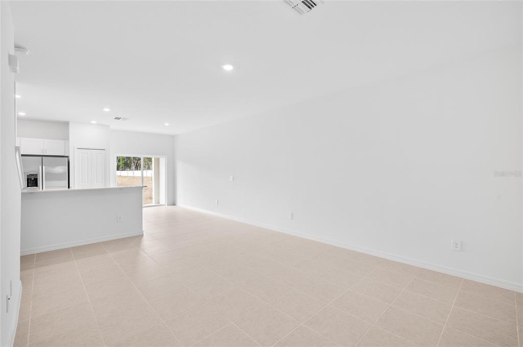36148 Risa Michele Street Zephyrhills, FL 33541 - Photo 6 of 34 a view of an empty room with kitchen