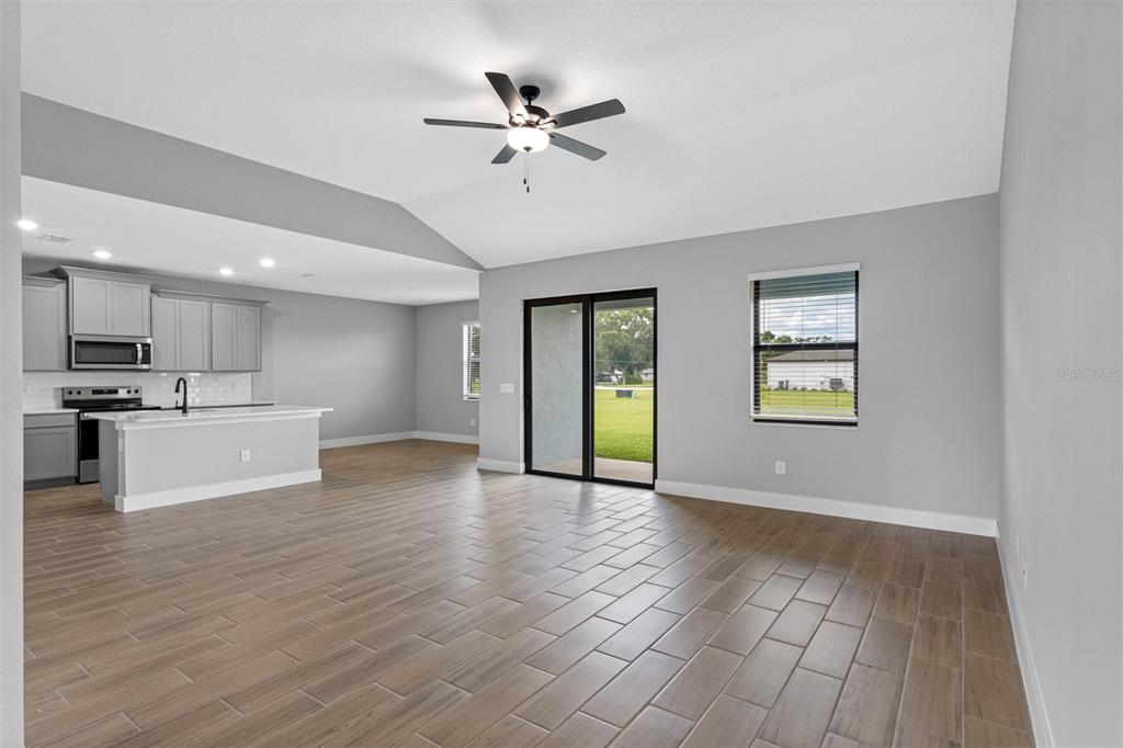 13521 Walden Sheffield Road Dover, FL 33527 - Photo 2 of 7 a view of an empty room with window and wooden floor