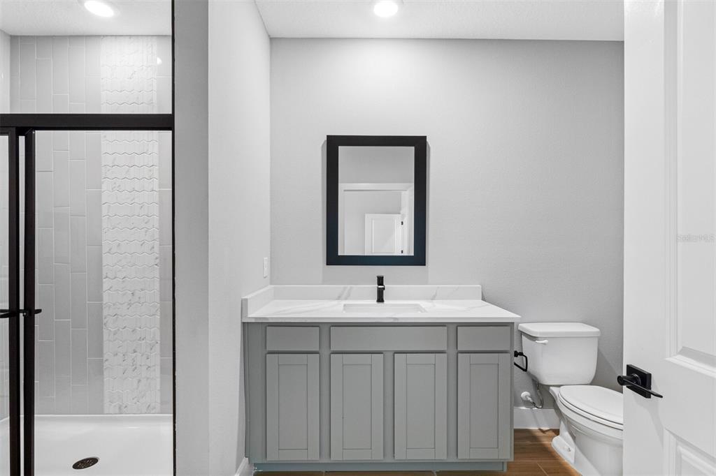 13521 Walden Sheffield Road Dover, FL 33527 - Photo 5 of 7 a bathroom with a sink toilet vanity and shower