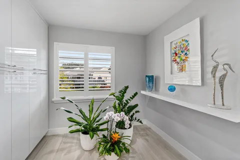 a kitchen with stainless steel appliances a refrigerator sink and white cabinets