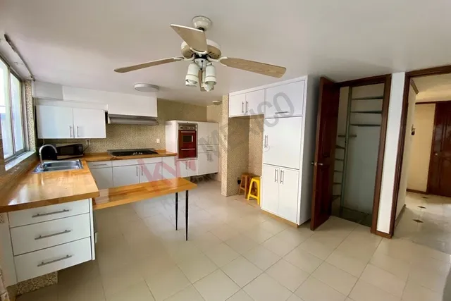 a kitchen with stainless steel appliances kitchen island granite countertop a refrigerator and a stove top oven