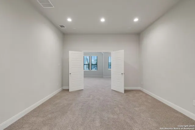 an empty room with a empty space and windows