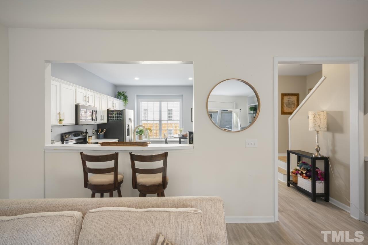 7106 Proctor Hill Drive Raleigh, NC 27613 - Photo 14 of 29 a kitchen with kitchen island a white cabinets and window