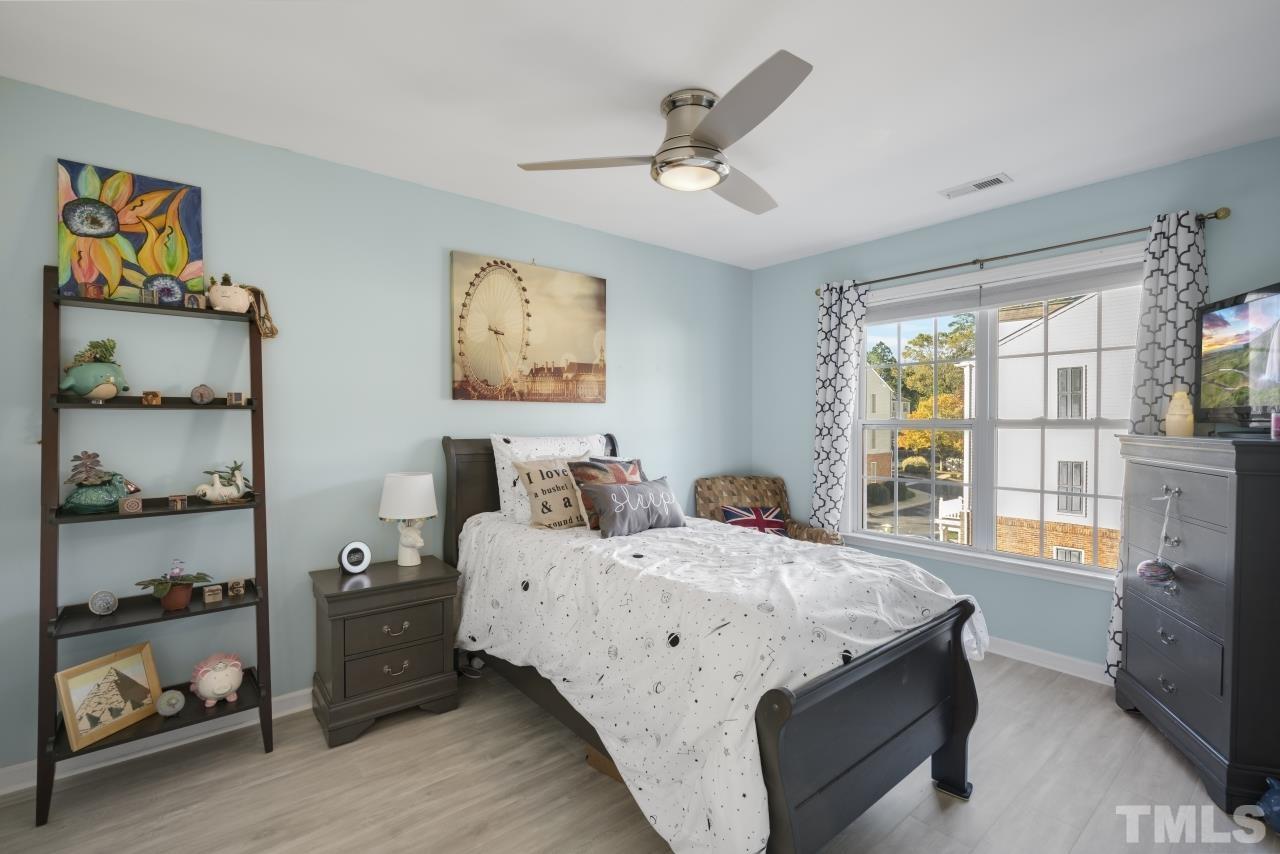 7106 Proctor Hill Drive Raleigh, NC 27613 - Photo 23 of 29 a bedroom with a bed and a chandelier