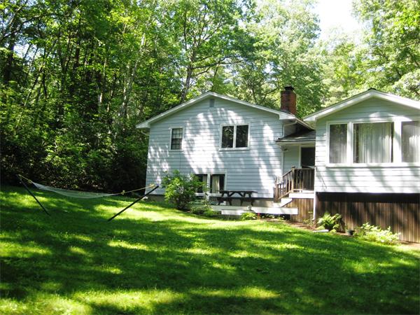 103 Temple Road Concord, MA 01742 - Photo 5 of 6 a backyard of a house with table and chairs
