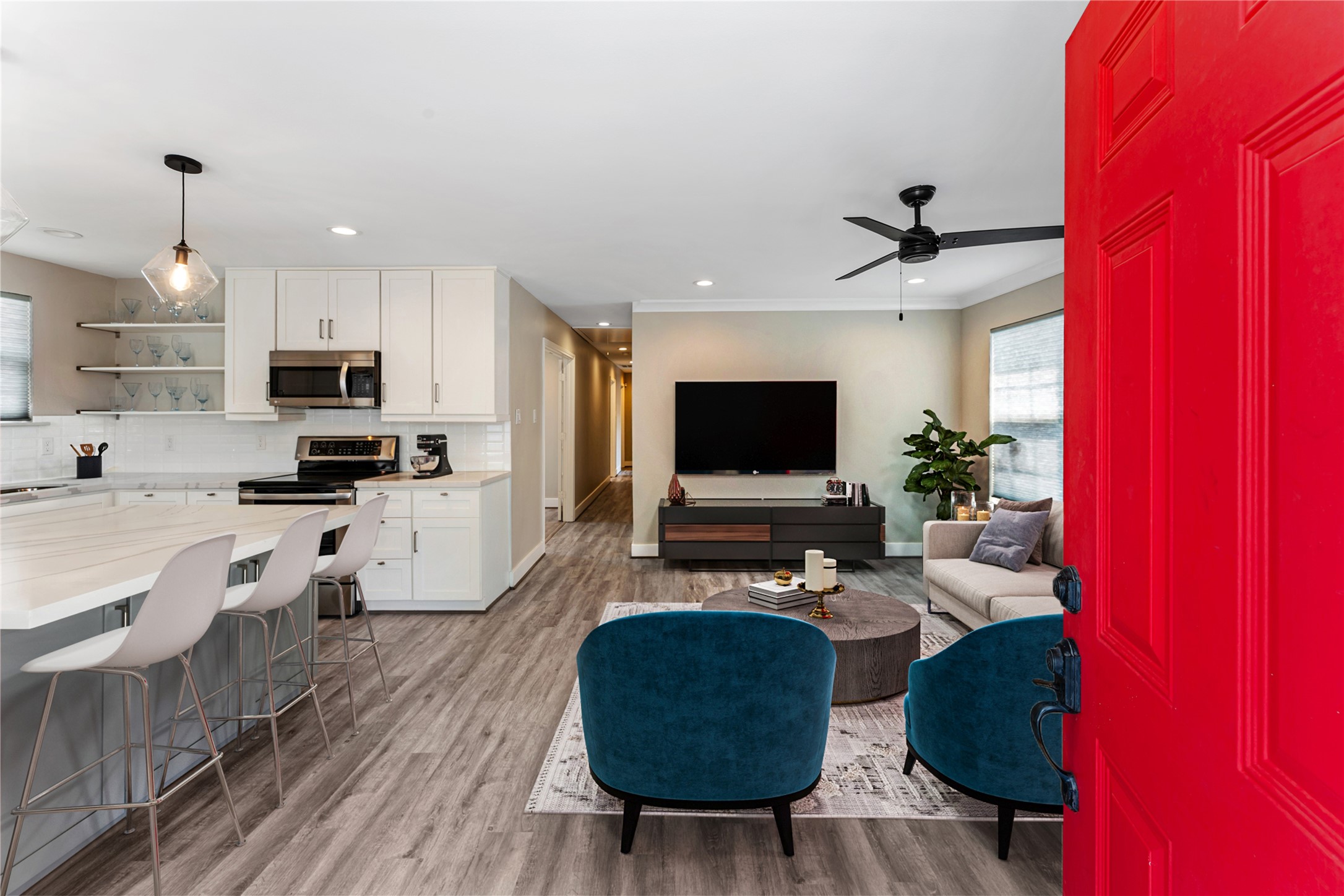 809 East 40th Street Houston, TX 77022 - Photo 5 of 27 Open-concept living connects the updated kitchen to a spacious living area, enhanced by new flooring and updated lighting throughout. Perfect for entertaining or everyday living with a clean, modern feel. virtually staged