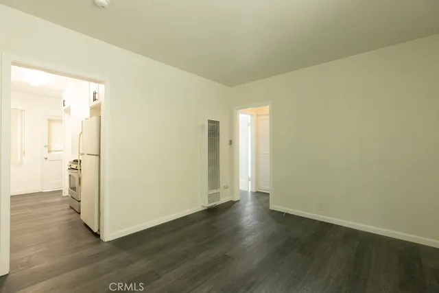 a view of a room with wooden floor