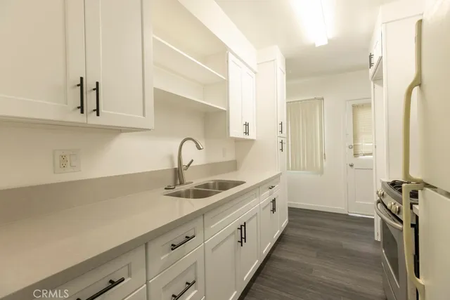 a kitchen with stainless steel appliances a sink and a stove