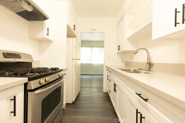 a kitchen with a stove and a sink
