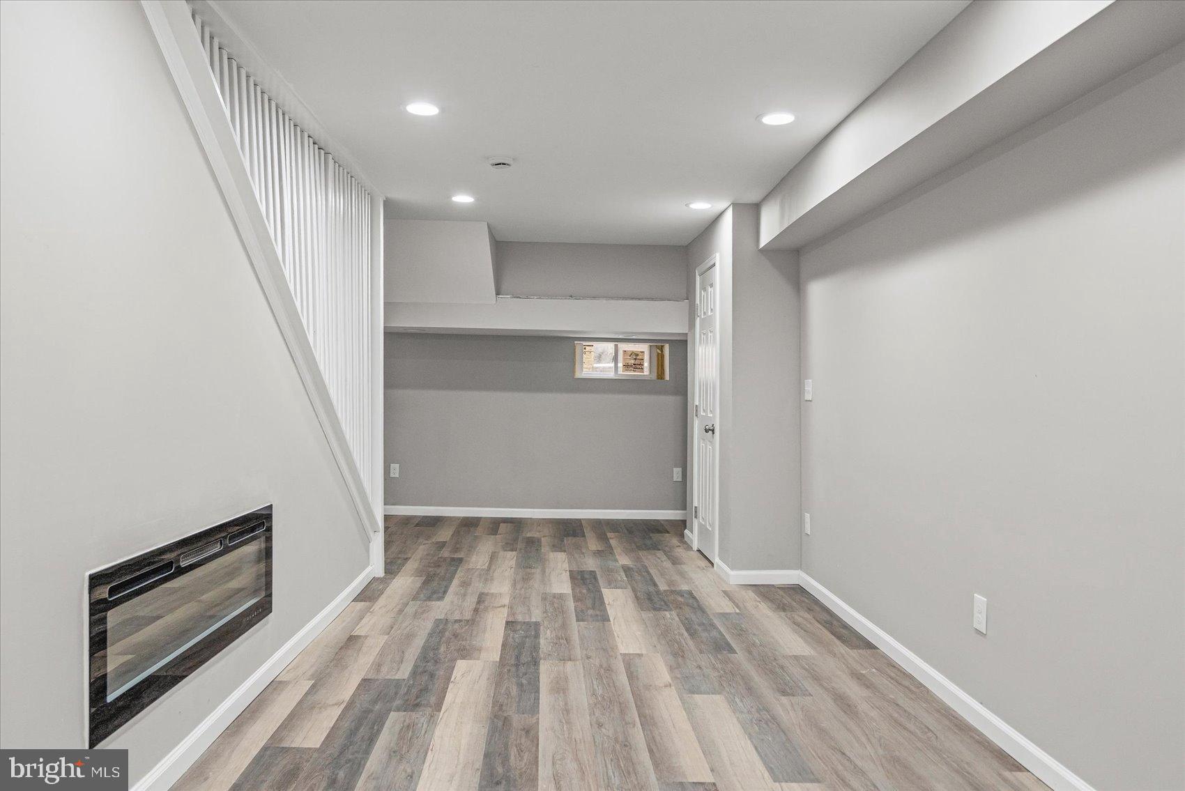 407 Pitman Place Baltimore, MD 21202 - Photo 12 of 42 a view of hallway with stairs and wooden floor