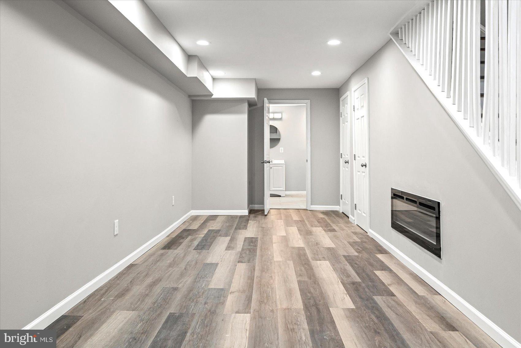 407 Pitman Place Baltimore, MD 21202 - Photo 13 of 42 a view of empty room with wooden floor and fan