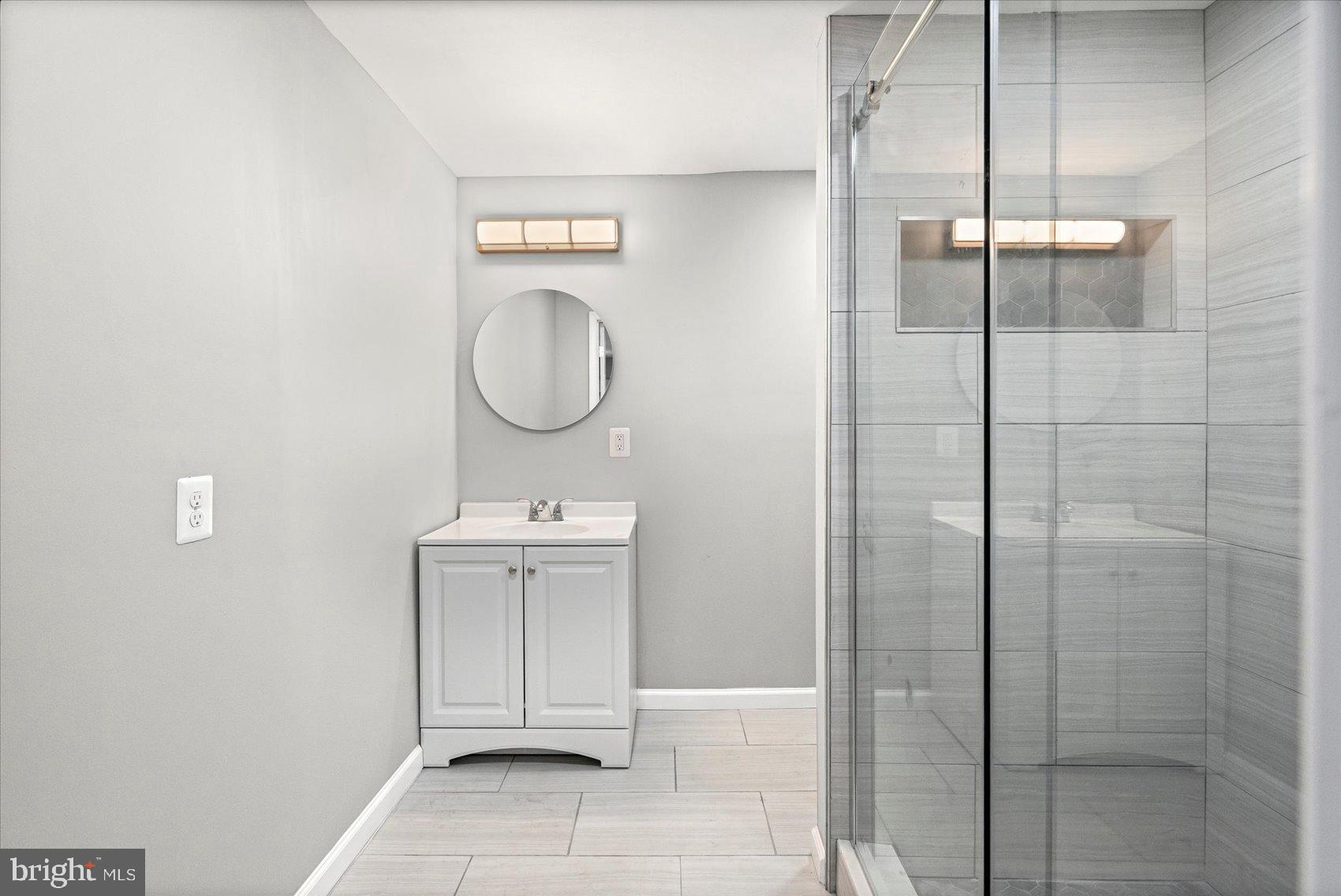 407 Pitman Place Baltimore, MD 21202 - Photo 16 of 42 a bathroom with a sink a toilet and shower