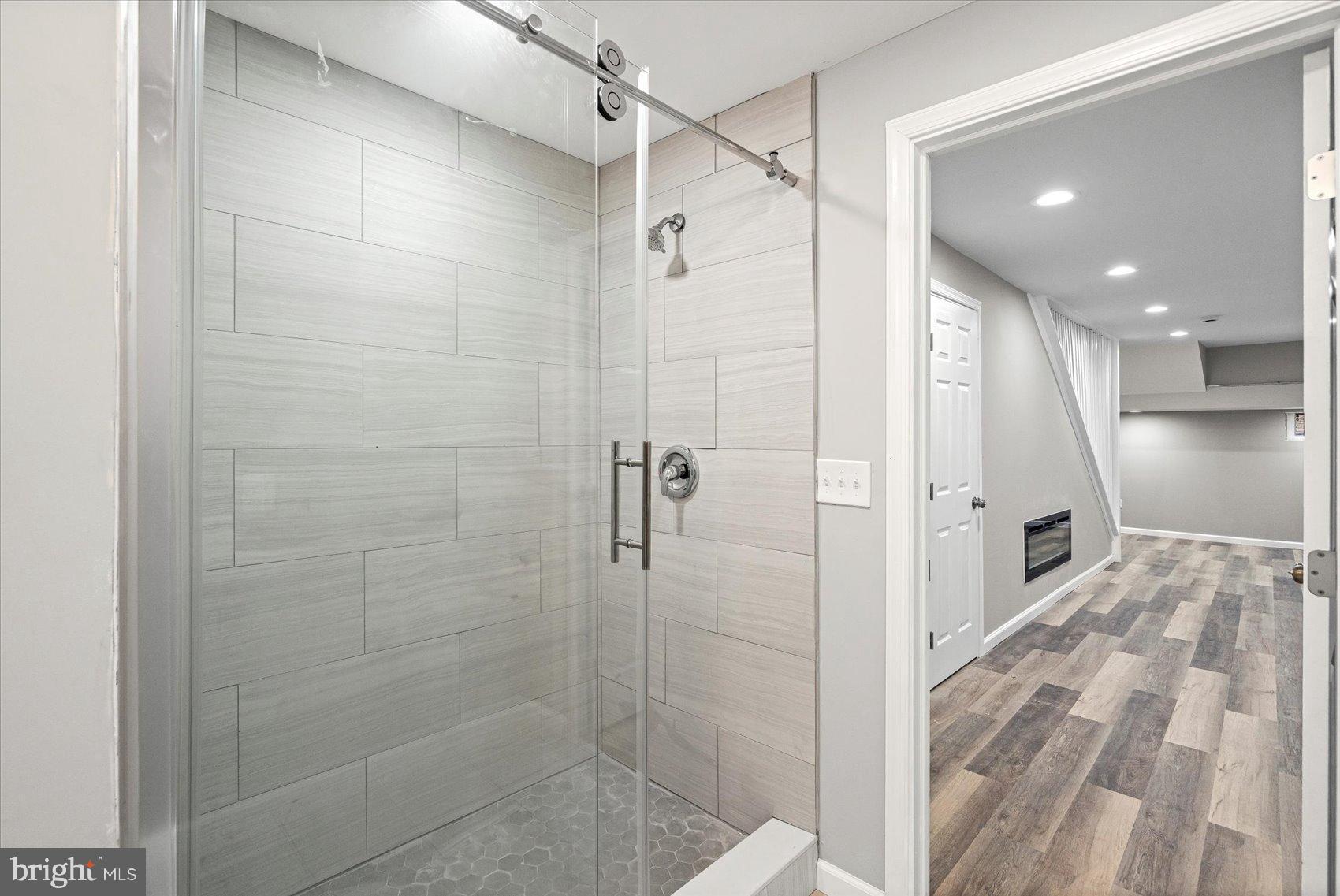 407 Pitman Place Baltimore, MD 21202 - Photo 17 of 42 a bathroom with a glass shower door and a shower