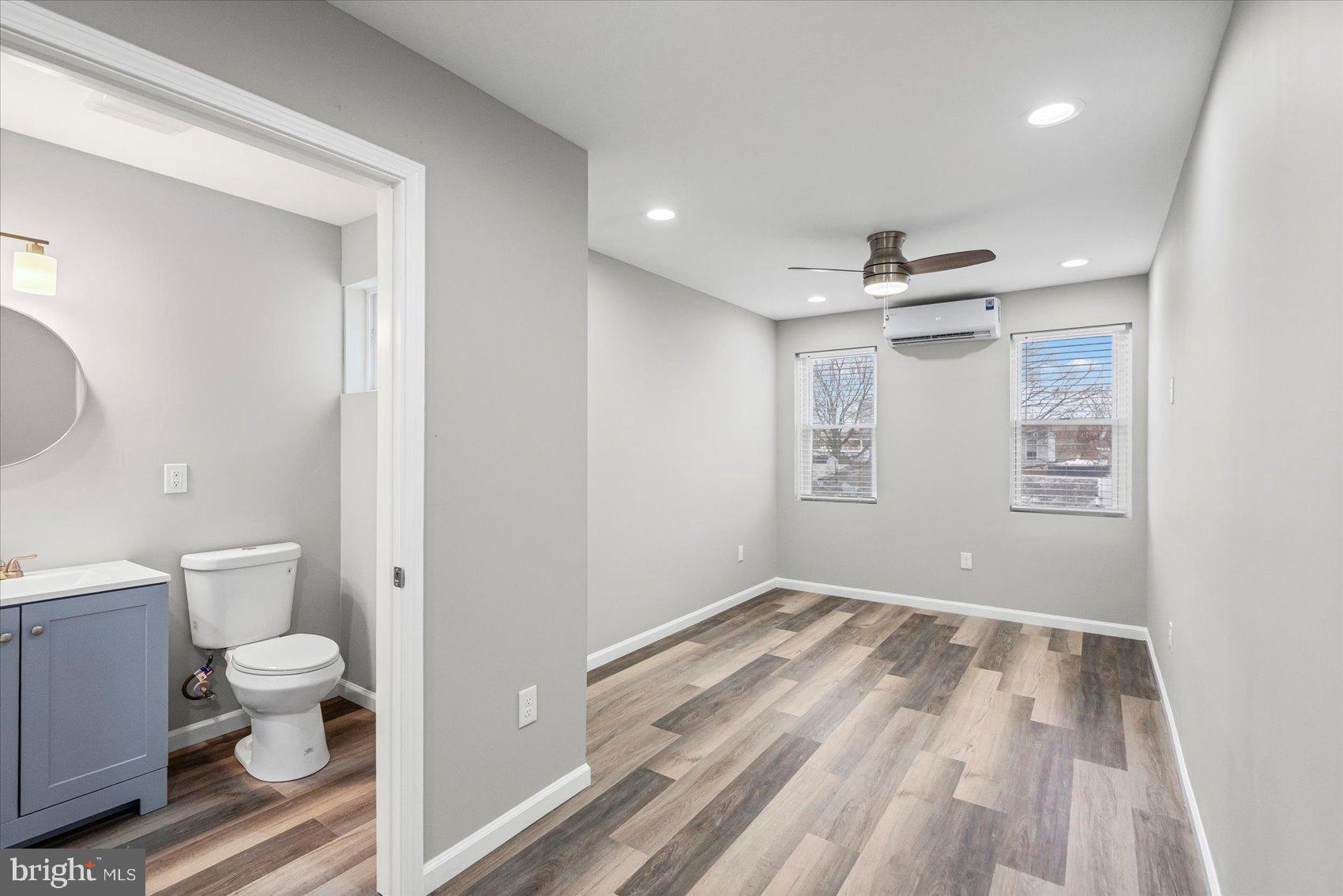 407 Pitman Place Baltimore, MD 21202 - Photo 23 of 42 a bathroom with a toilet sink and a mirror