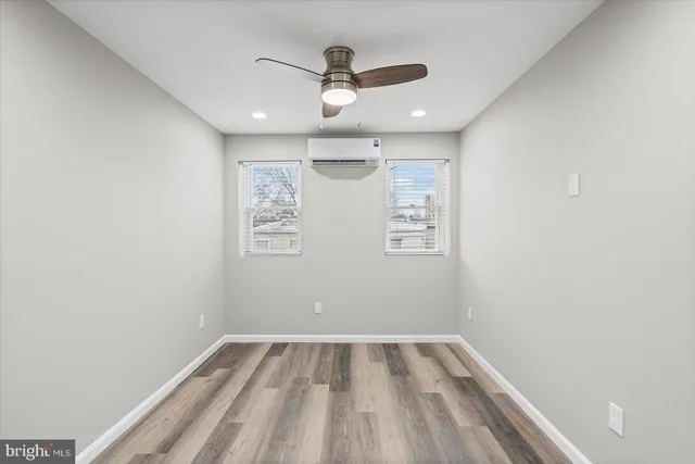 a view of a room with a ceiling fan