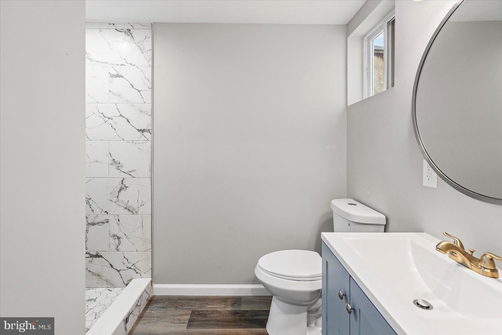 407 Pitman Place Baltimore, MD 21202 - Photo 27 of 42 a bathroom with a sink a toilet and shower