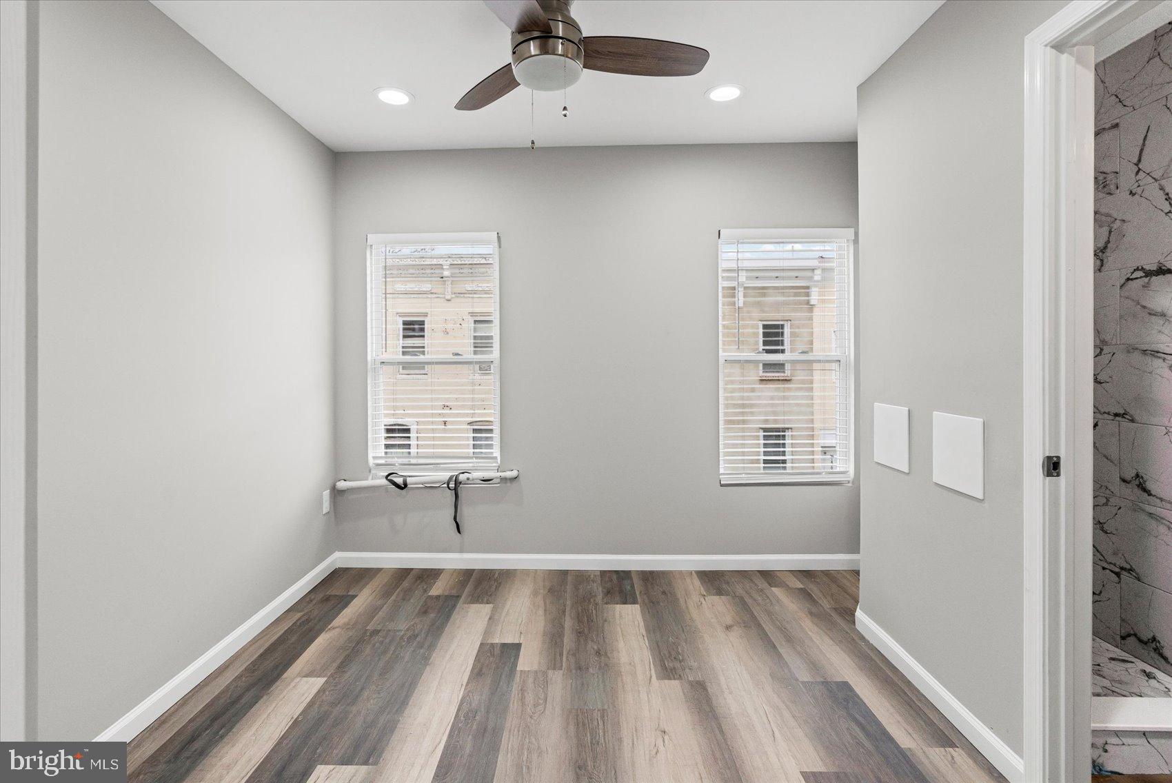 407 Pitman Place Baltimore, MD 21202 - Photo 29 of 42 wooden floor in an empty room with a window