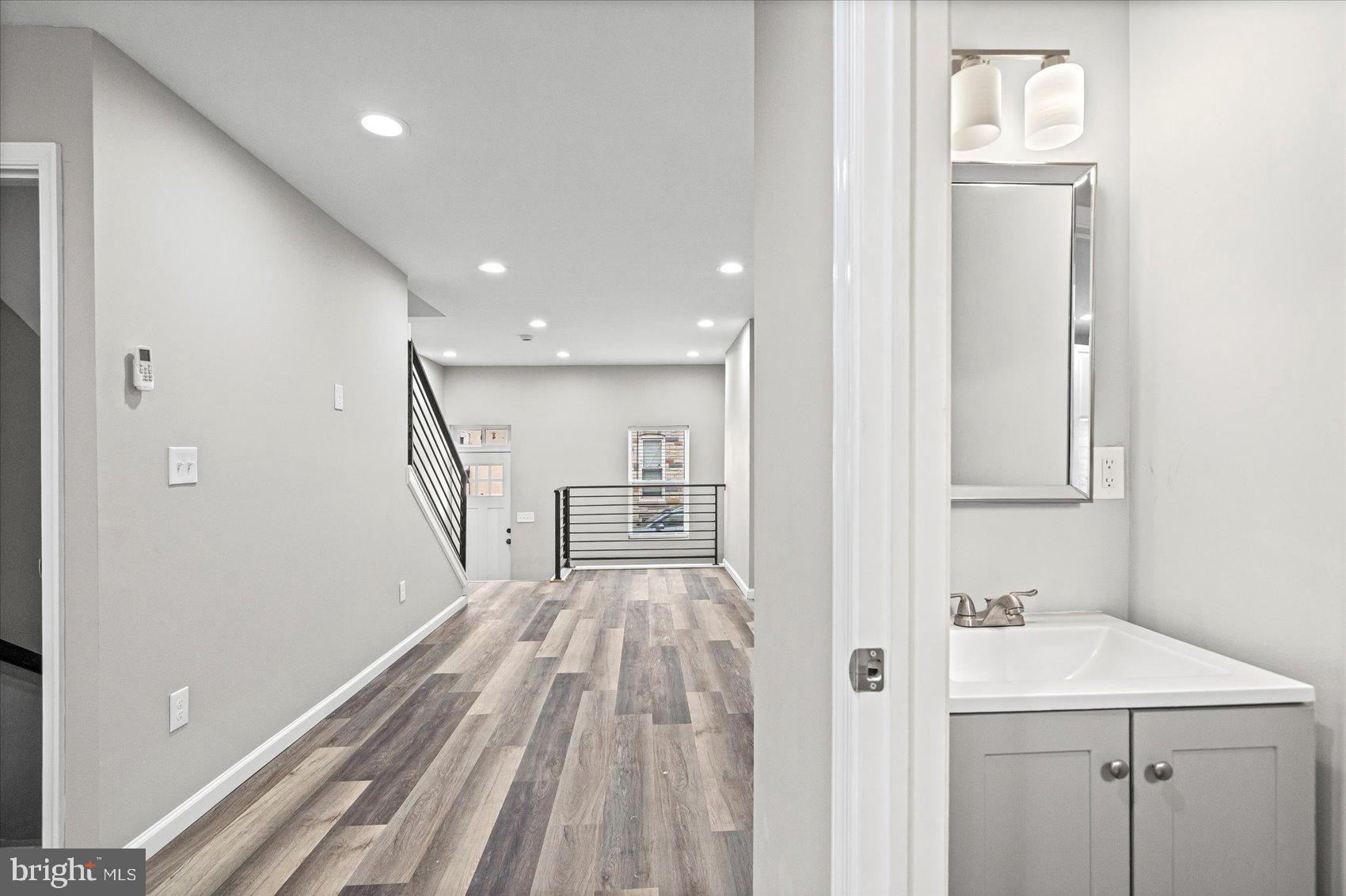 407 Pitman Place Baltimore, MD 21202 - Photo 5 of 42 a view of a hallway with wooden floor and staircase