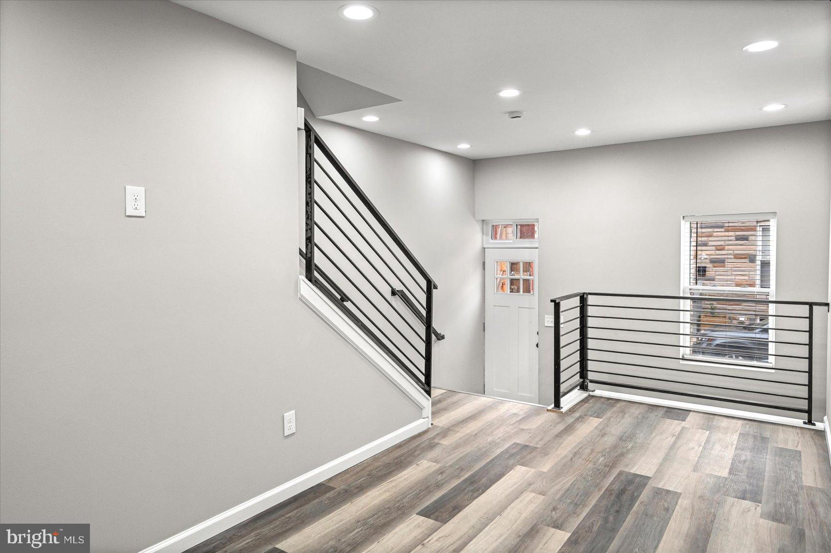 407 Pitman Place Baltimore, MD 21202 - Photo 7 of 42 a view of a hallway with stairs and furniture