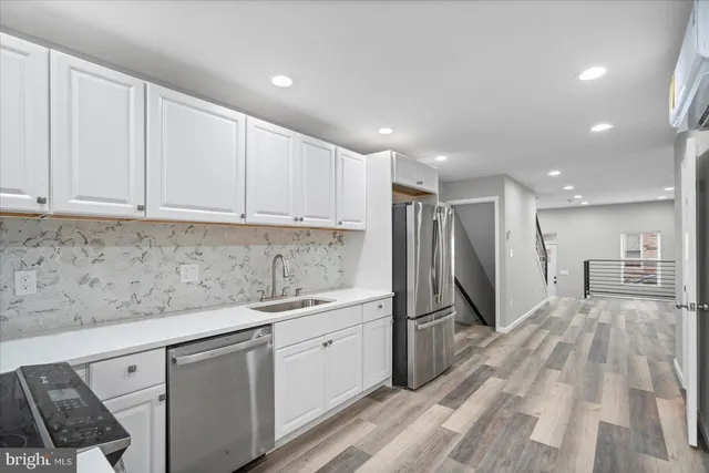 a kitchen with a sink appliances and cabinets