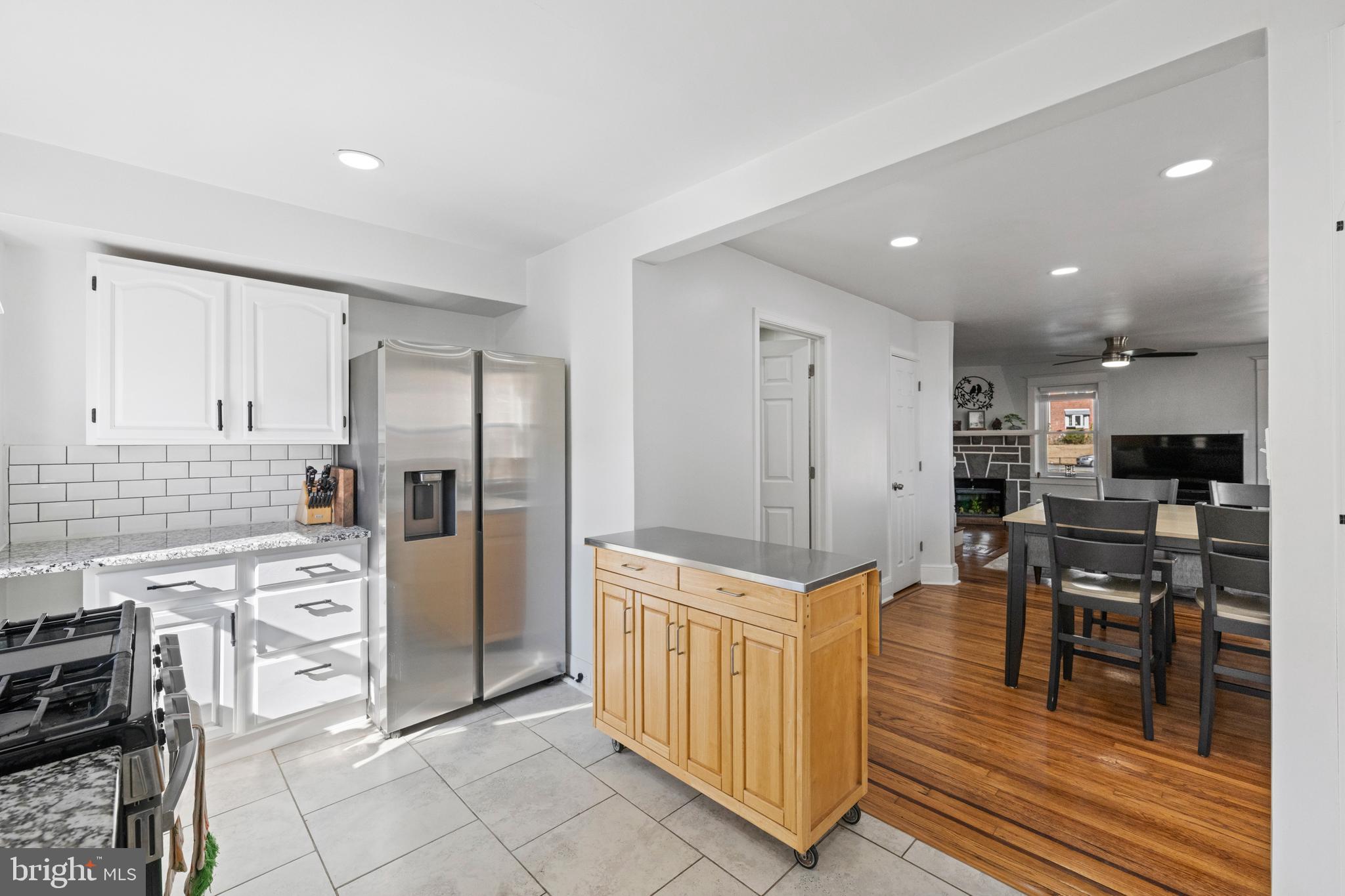 116 Marshall Road Lansdowne, PA 19050 - Photo 17 of 40 a kitchen with stainless steel appliances kitchen island granite countertop a refrigerator and cabinets