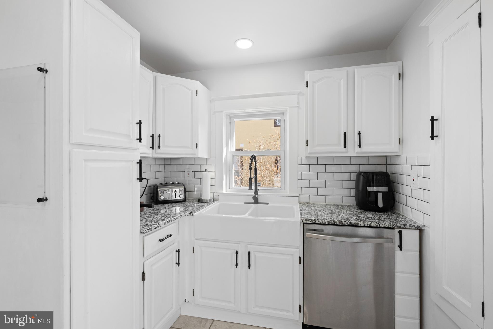 116 Marshall Road Lansdowne, PA 19050 - Photo 18 of 40 a kitchen with white cabinets and a sink